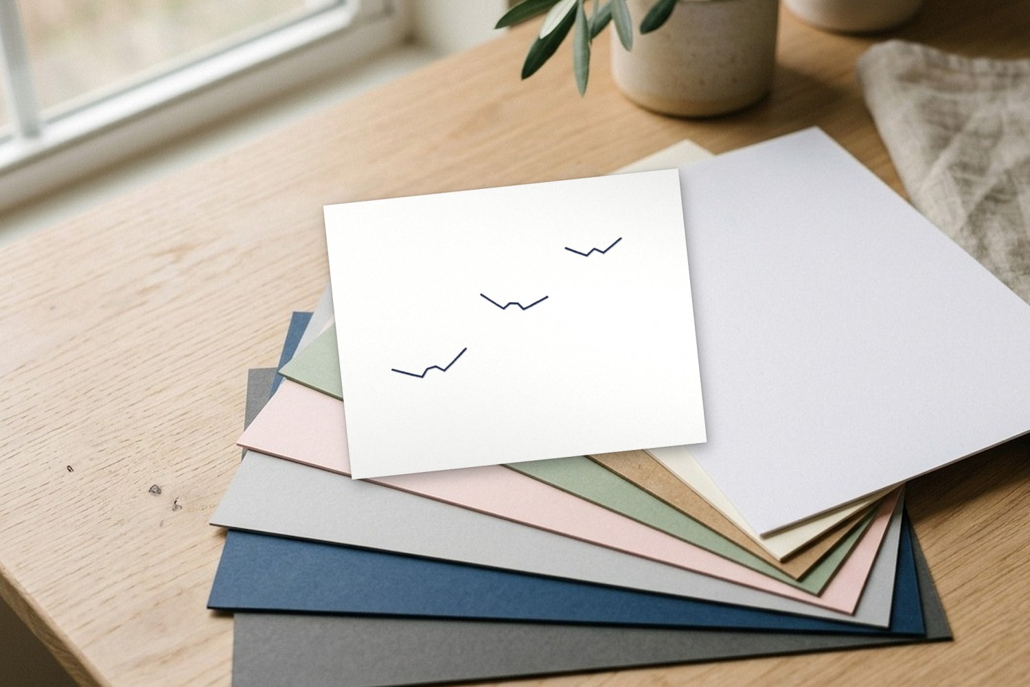 Three stitched swallows on a card
